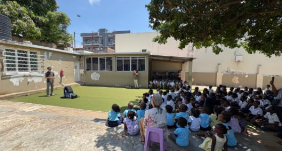Drone demonstration for pupils sitting in a school yard in Maputo