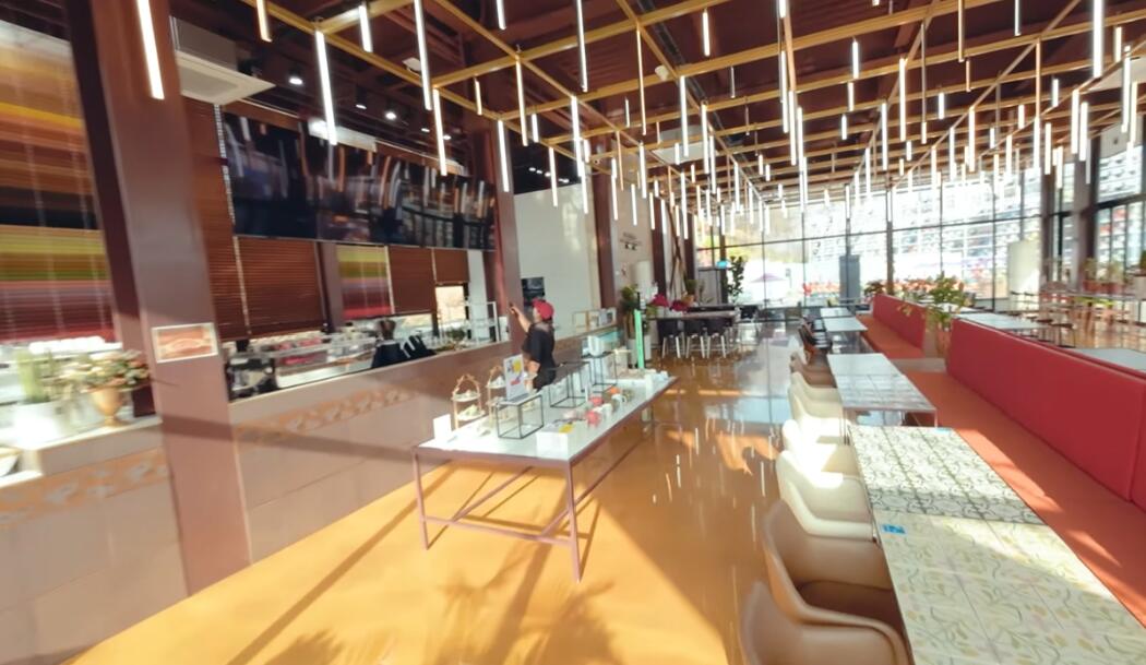 Café interior with a wooden ceiling and hanging lights